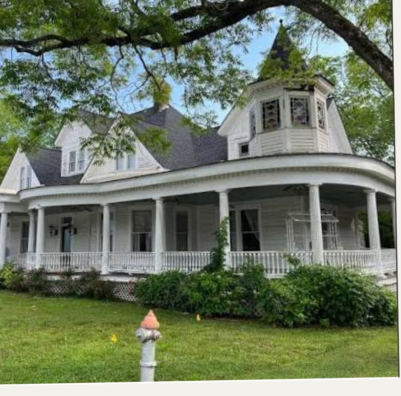 The Inn on 411, a white Victorian house with a wraparound porch.